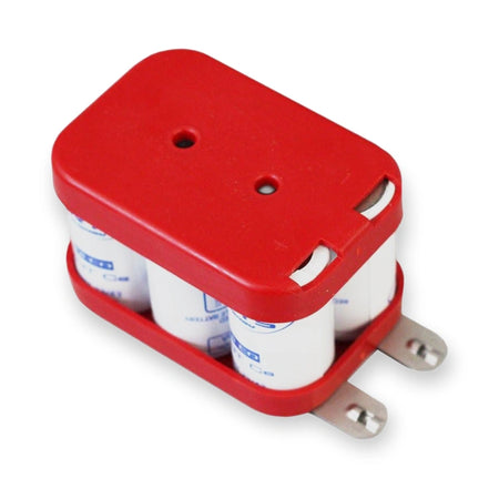 Orona Battery 6V 1.2Ah Emergency Light 5123020-1, top-down view showing red plastic cover, white cylindrical capacitors, and metal terminals, on white background.