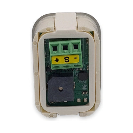 Back of LiftLogic KK35 RGB push button showing the circuit board, buzzer and + S - screw terminal, on white background.