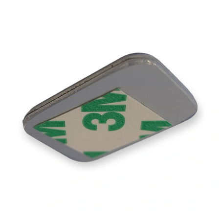 Back of LiftLogic KK35 green aluminium button cap with the 3M adhesive pad, on white background.
