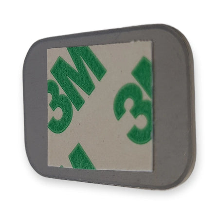 Back of LiftLogic KK35 stainless steel button cap with the 3M adhesive pad, on white background.