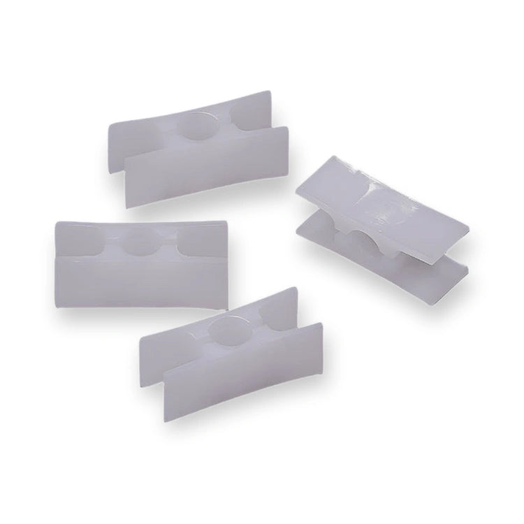 Fermator Compact 40x15mm Door Guide KM51415338, top-down view of white plastic clips with circular indentations, on white background.
